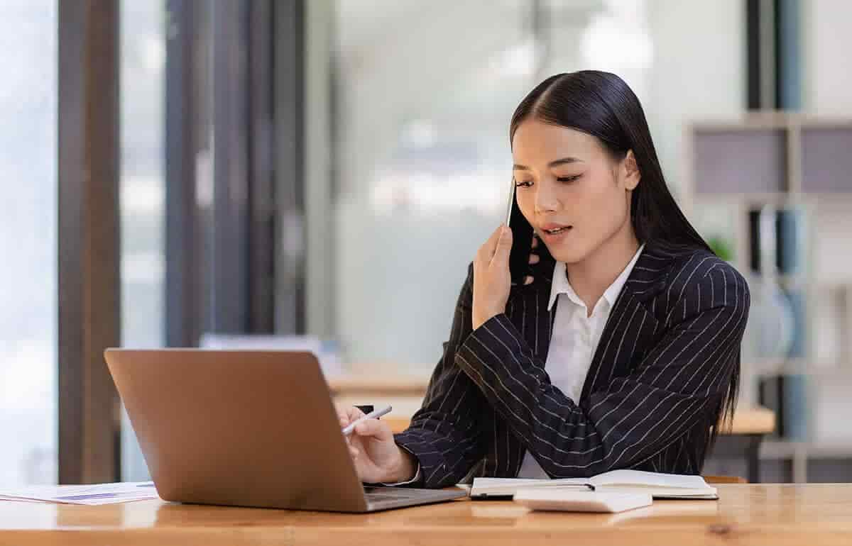 female lawyer speaking on phone at desk