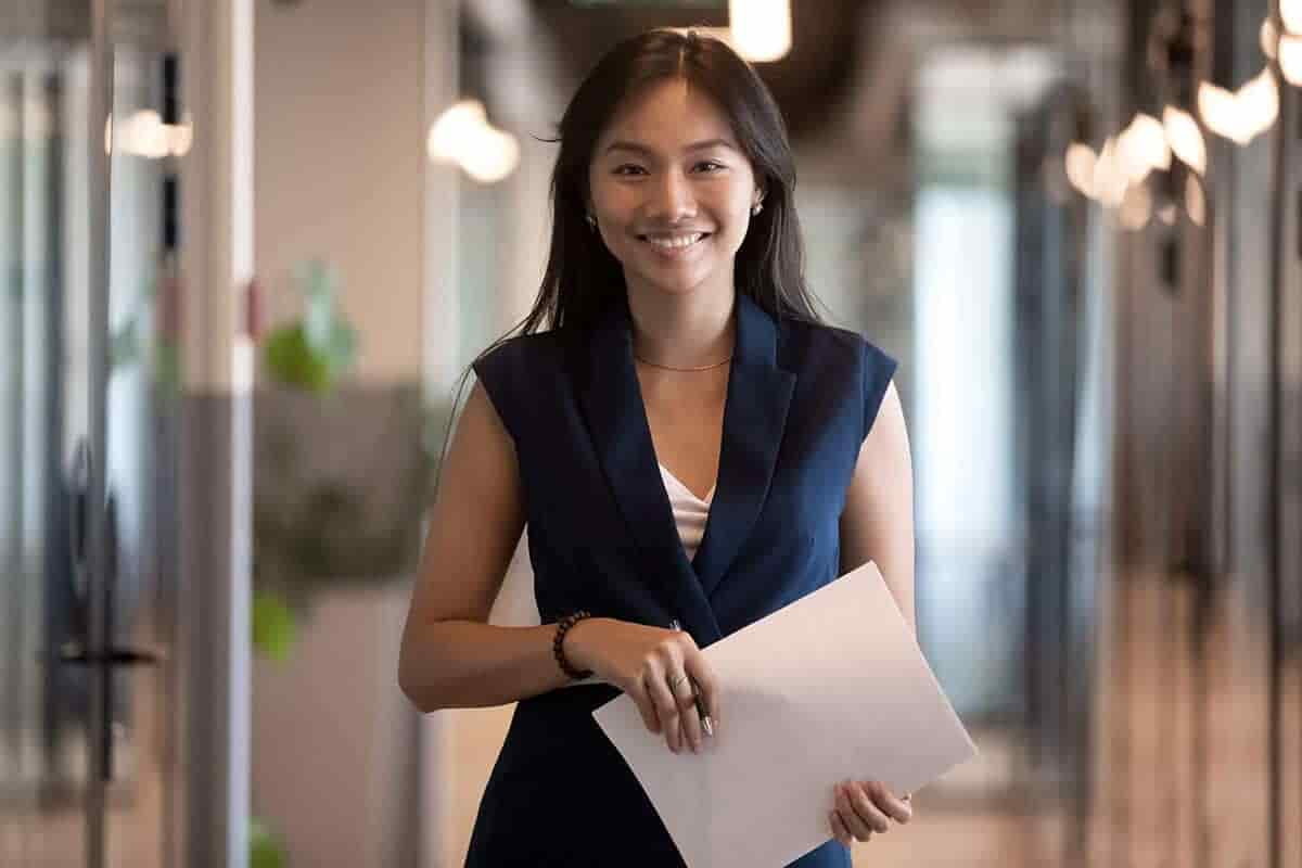 female attorney holding documents in an office hallway