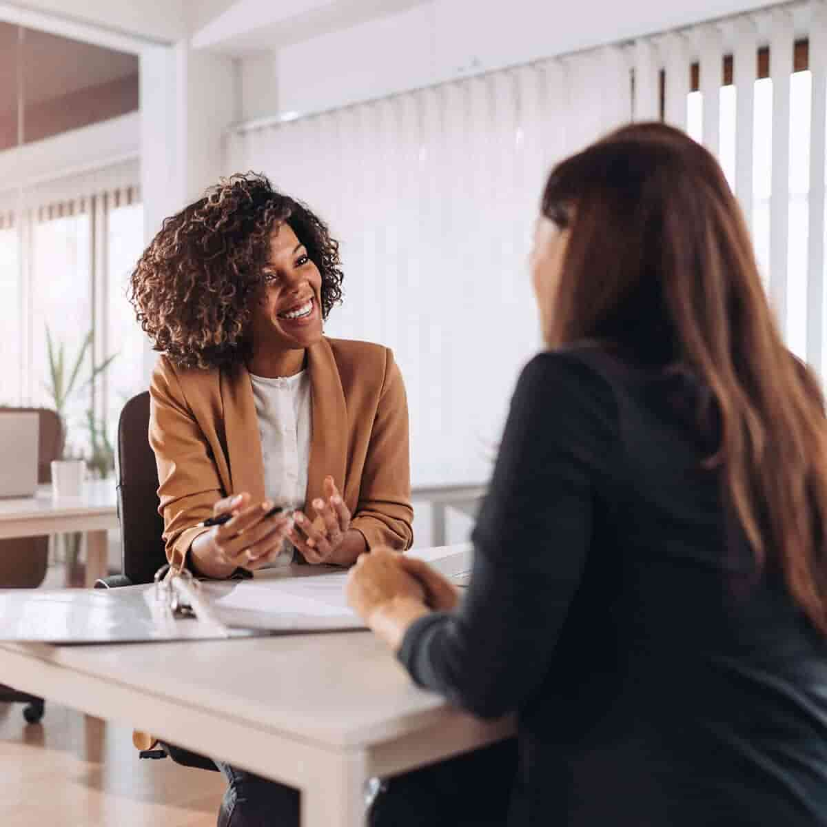 two women chatting at work